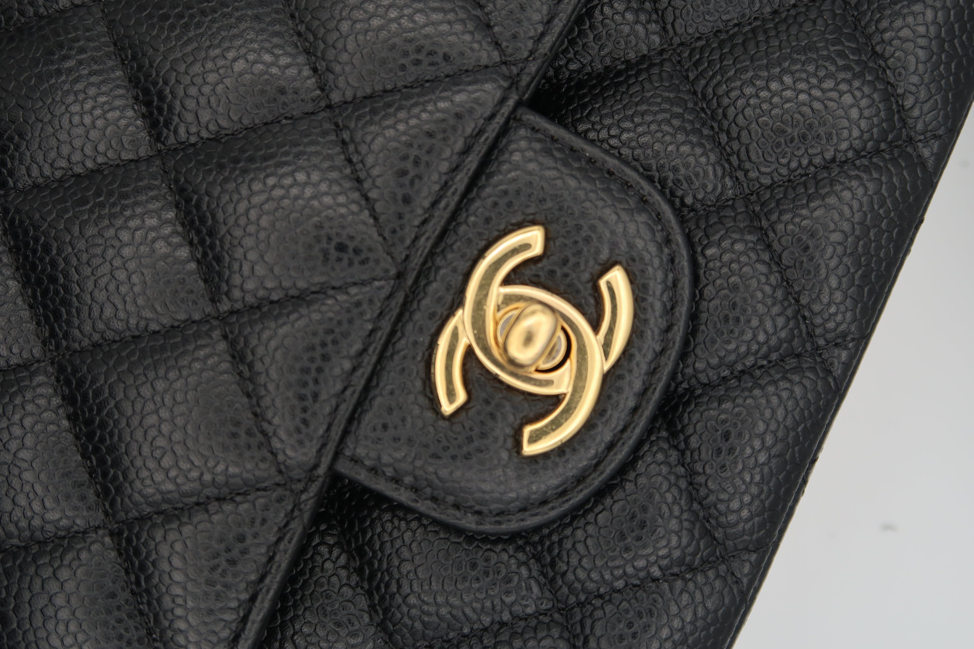 CC turn-lock on Chanel Classic Flap in black caviar