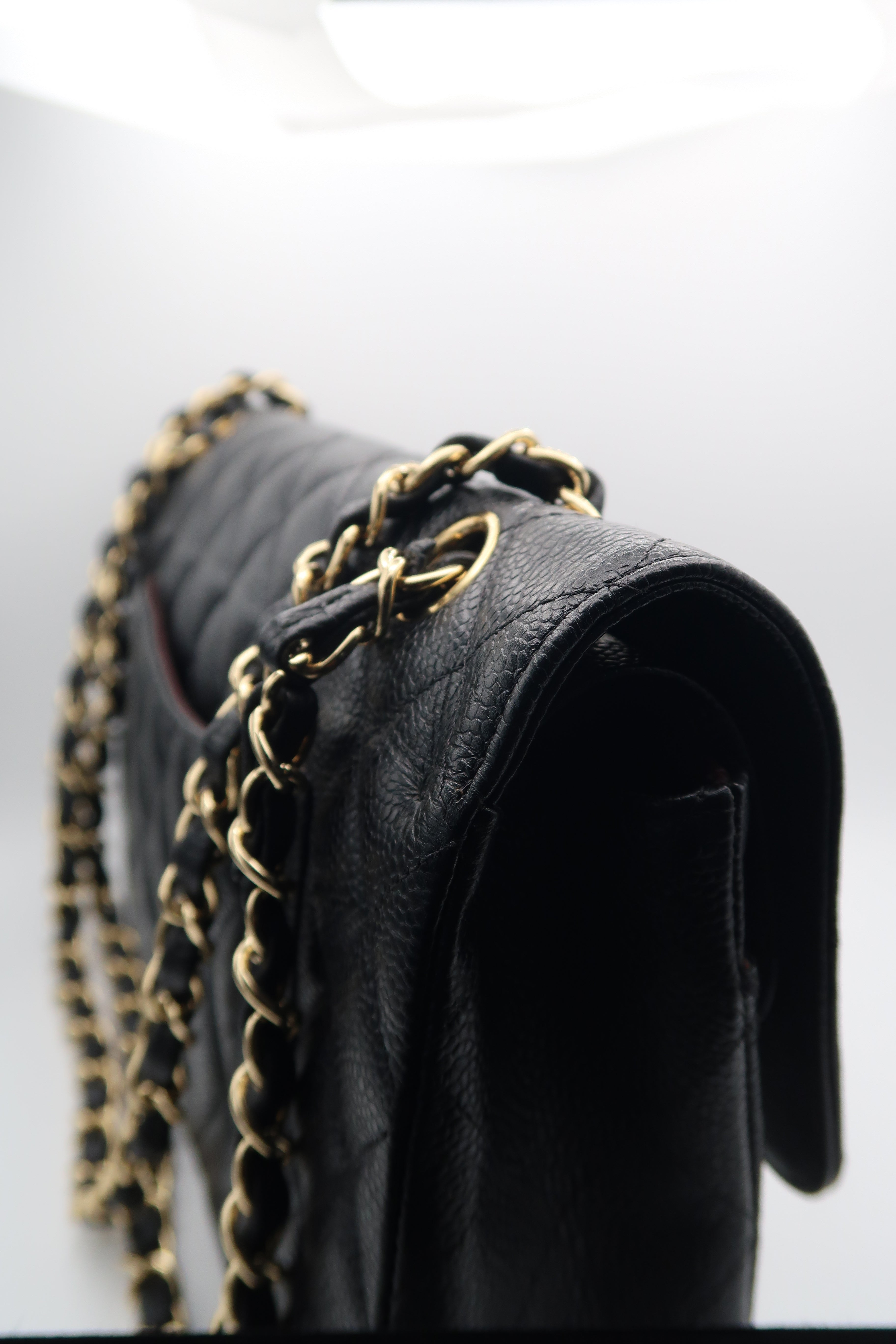 right side view of Chanel Classic Flap in black caviar