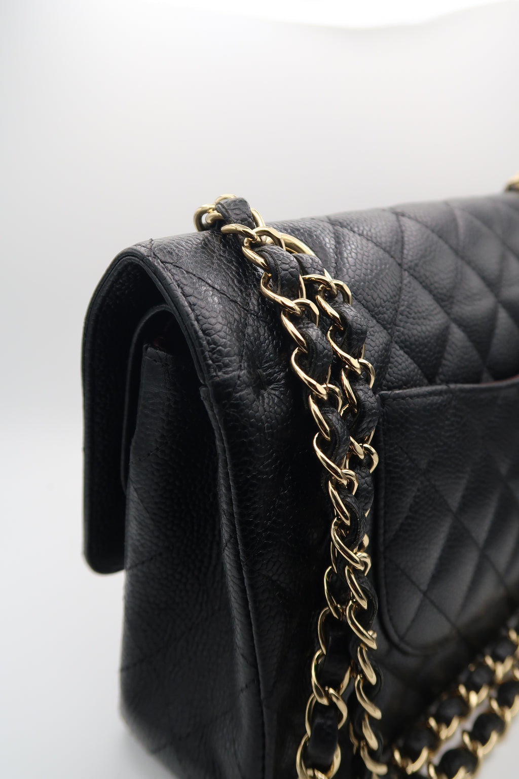 left side view of Chanel Classic Flap in black caviar