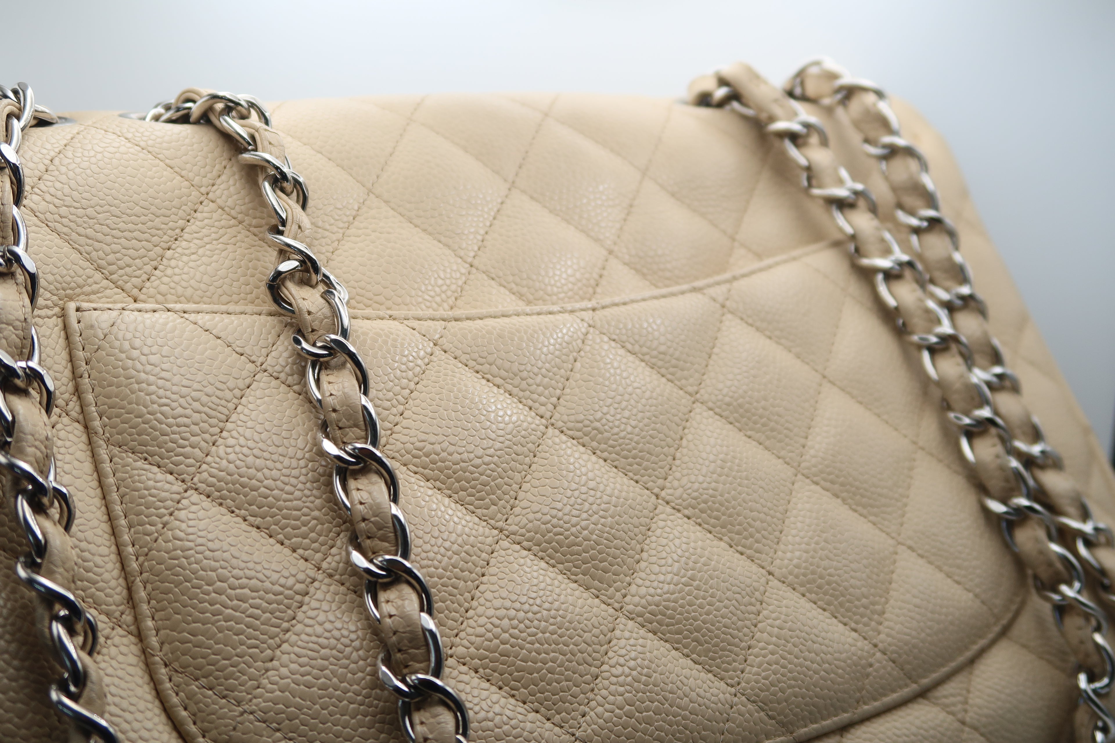 close-up of Chanel Classic Jumbo in beige caviar