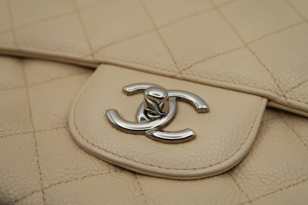 Silver CC turn-lock closure on Chanel Classic Jumbo in beige caviar
