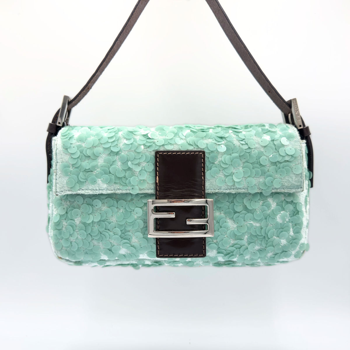 A mint green sequined shoulder bag with a dark brown leather front panel and a silver-tone FF logo clasp, shown against a plain white background.