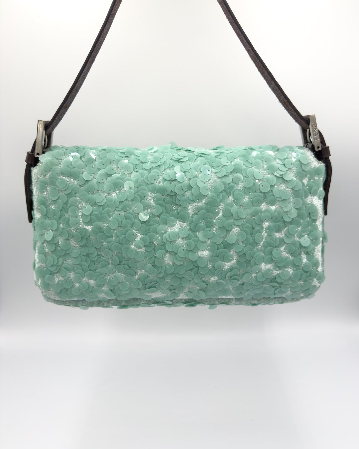 A mint green sequined shoulder bag with a black strap and silver hardware, shown against a plain white background.